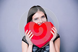 Happy beautiful woman holding red heart photo