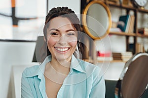 Happy beautiful woman in the house posing near the mirror, looking at the camera with a smile