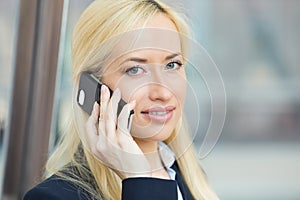 Happy beautiful woman laughing, speaking on cell phone