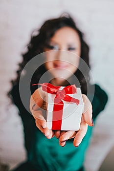 Happy beautiful woman opening present for Valentine's Day