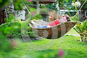 Happy beautiful woman relaxing in hammock