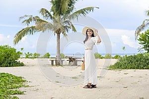 happy beautiful woman in white dress enjoying and relaxing on the beach  Summer and holidays concept