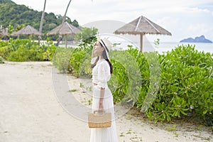 happy beautiful woman in white dress enjoying and relaxing on the beach  Summer and holidays concept