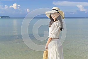 happy beautiful woman in white dress enjoying and relaxing on the beach  Summer and holidays concept