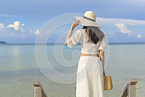 Happy beautiful woman in white dress enjoying and relaxing on the beach, Summer and holidays concept