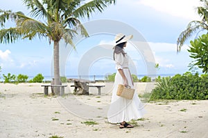 Happy beautiful woman in white dress enjoying and relaxing on the beach, Summer and holidays concept