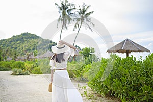 Happy beautiful woman in white dress enjoying and relaxing on the beach, Summer and holidays concept