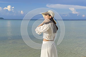 Happy beautiful woman in white dress enjoying and relaxing on the beach, Summer and holidays concept