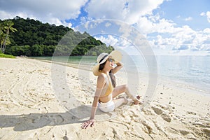 happy beautiful woman in yellow bikini enjoying and relaxing on the beach, Summer and holidays concept