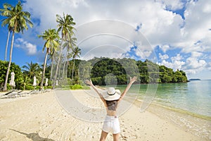 Happy beautiful woman in yellow bikini enjoying and relaxing on the beach, Summer and holidays concept