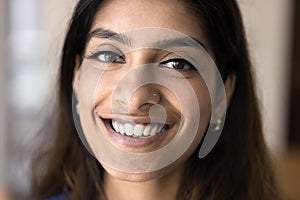 Happy beautiful young 20s Indian girl face close up