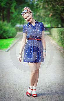 Happy beautiful young girl in fifties style with braces