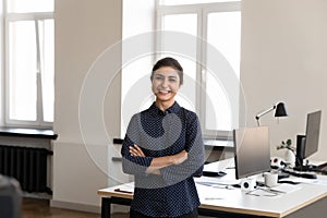 Happy beautiful young Indian business leader woman looking at camera