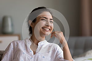 Happy beautiful young Indian woman looking at window