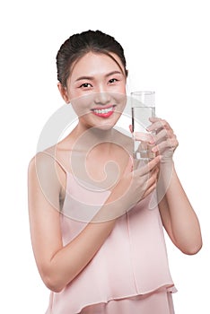 Happy beautiful young vietnamese woman drinking water.