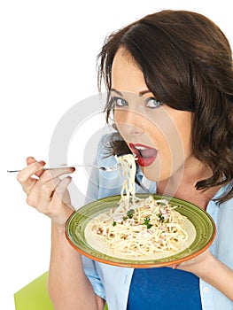 Happy Beautiful Young Woman Eating a Plate of Spaghetti Carbonara Pasta