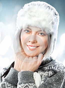 Happy beautiful young woman in fur cap