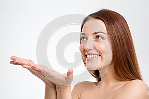 Happy beautiful young woman holding copyspace on palms