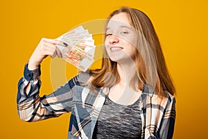 Happy beautiful young woman holding rubles money. Sale, finance, banking, winning, economic, credit, business, shopping concept.