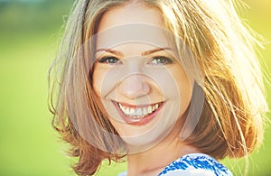 Happy beautiful young woman laughing and smiling on nature