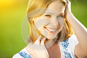 Happy beautiful young woman laughing and smiling on nature