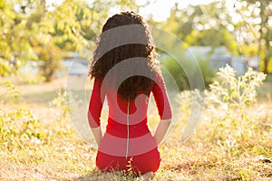 Happy beautiful young woman in red dress relax in summer park. Freedom concept