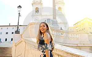 Happy beautiful young woman on the Spanish Steps famous landmark of Rome. Summer holidays in Italy