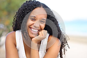 Happy beauty black woman with perfect smile on the beach