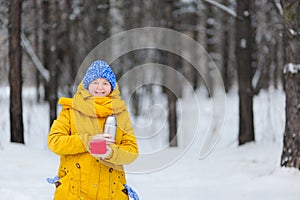 Happy beauty woman basking in the winter a hot drink.