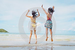 Happy beauty woman in bikini jumping together on the beach