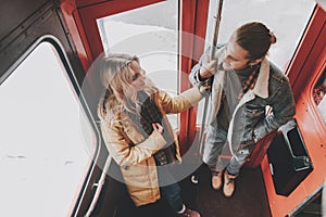 Happy beloved couple staying on back side of bus