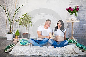 Happy beloved man and pregnant woman at home