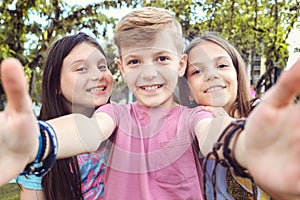 Happy best friends kids taking selfie outdoors in garden party