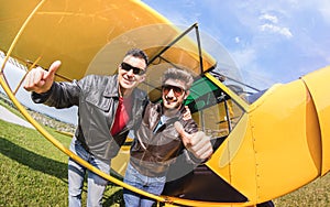 Happy best friends taking selfie at aeroclub with ultra light airplane