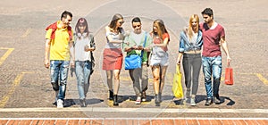 Happy best friends walking and talking in city center - Tourist guys and girls millennial having fun around town streets -