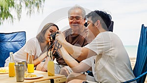 Happy big Asian family travel beach on holiday vacation