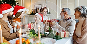 Happy big family with children exchanging gifts on Christmas morning at home