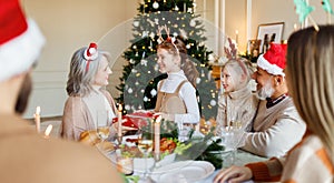 Happy big family with children exchanging gifts on Christmas morning at home