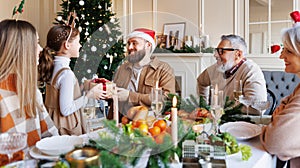 Happy big family with children exchanging gifts on Christmas morning at home