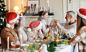 Happy big family with children exchanging gifts on Christmas morning at home