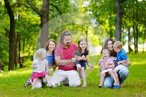 Happy big family having fun in summer park