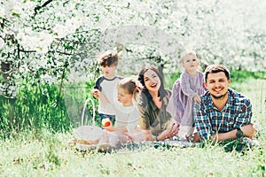 Happy big family mom dad and children daughters and son having fun outdoor in park smiling and laughing. Kids Childhood Lifestyle