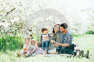 Happy big family mom dad and children daughters and son having fun outdoor in park smiling and laughing. Kids Childhood Lifestyle