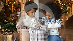 Happy biracial kids unbox gifts for Christmas photo