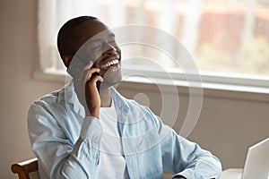 Happy biracial man laugh having cellphone call