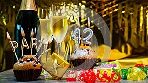 Happy birthday background with champagne glasses with number cake 42. Beautiful birthday card with decorations copy space