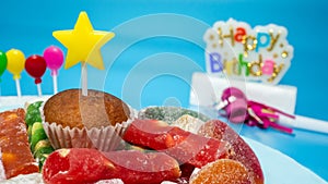 Happy birthday background copy space, happy birthday greeting card with cupcake and sweets on a blue background