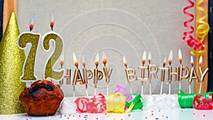 Happy birthday background with golden candles and decorations with candles burning number 72. Colorful festive card happy