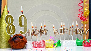 Happy birthday background with golden candles and decorations with candles burning number 89. Colorful festive card happy