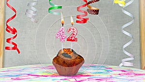 Happy birthday background with muffin with beautiful decorations with number candles 42. Colorful festive card happy birthday